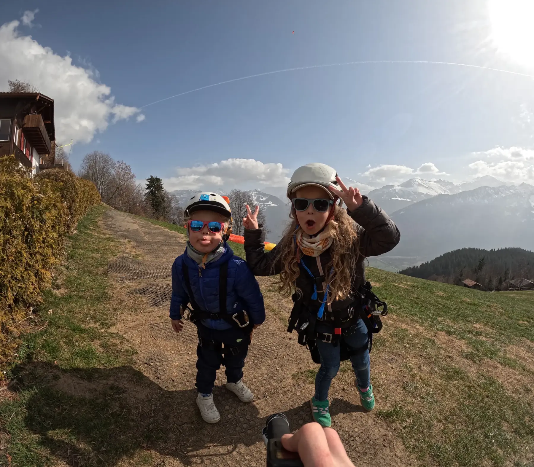 Drew's kids geared up for paragliding on a sunny launch above Interlaken