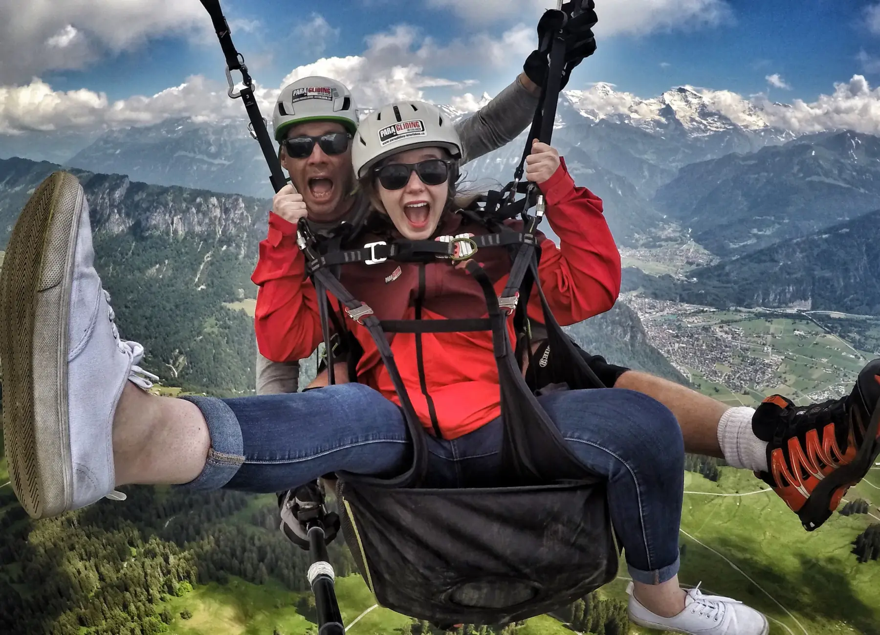 Excited tandem passenger mid-flight over Interlaken