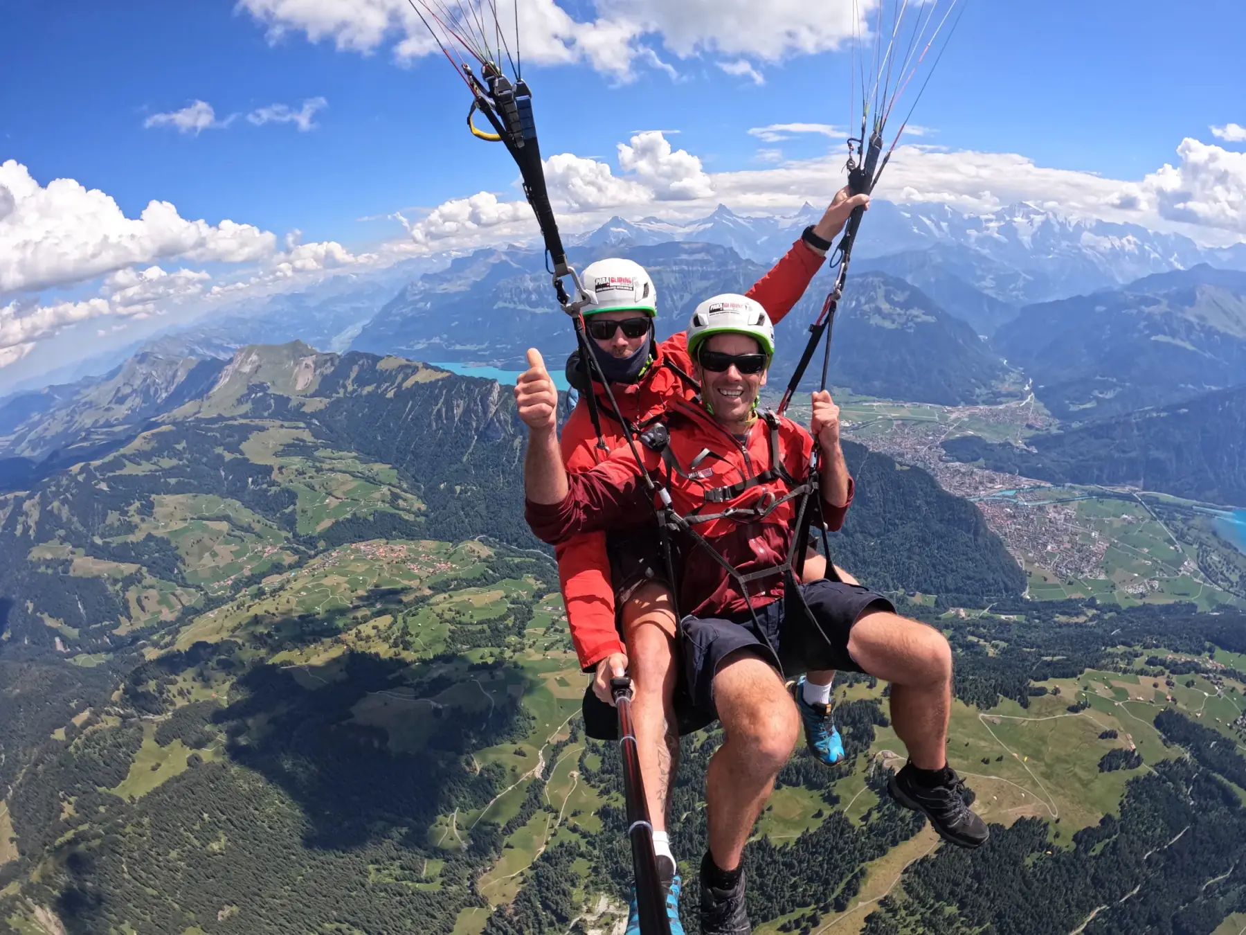 Tandem passenger giving a thumbs up over the Bernese Alps near Interlaken